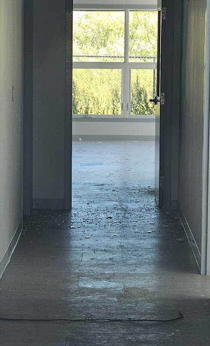 Broken glass visible in hallway.